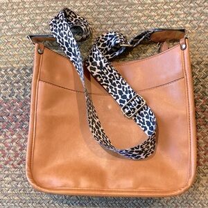 Like new faux leather bag. Adjustable animal print seat belt strap.